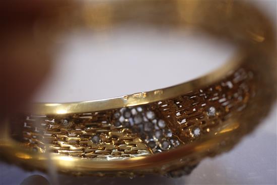 An 18ct yellow gold and diamond hinged bangle, of rod and sphere design, gross weight 59.3 grams.